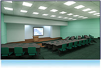 This impressive lecture hall showcases a large stage flanked by two video screens. Its a perfect for educational or technical video.